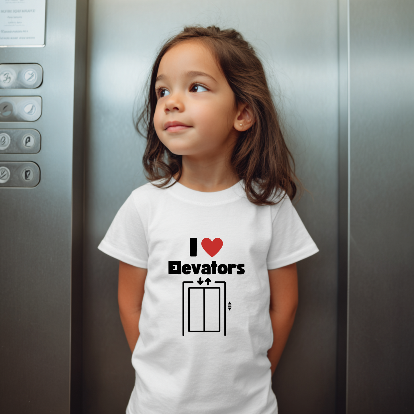 Child wearing a t-shirt with 'I ❤️ Elevators' design in an elevator.