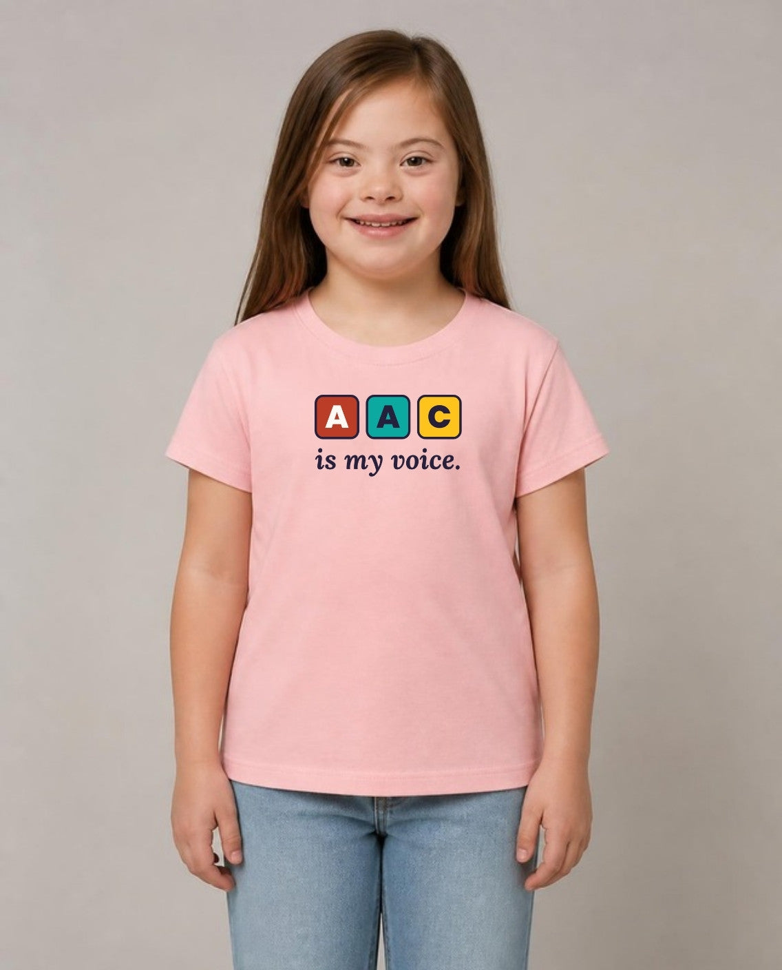 Girl with Down syndrome wearing the AAC Is My Voice Youth Tee in Pink