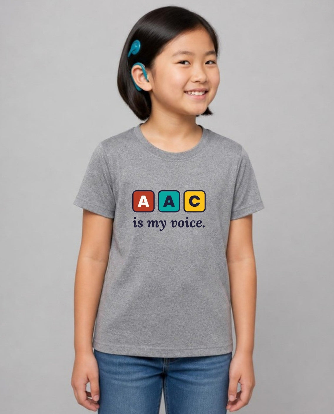 Girl with a cochlear implant wearing the AAC Is My Voice Youth Tee in Athletic Heather