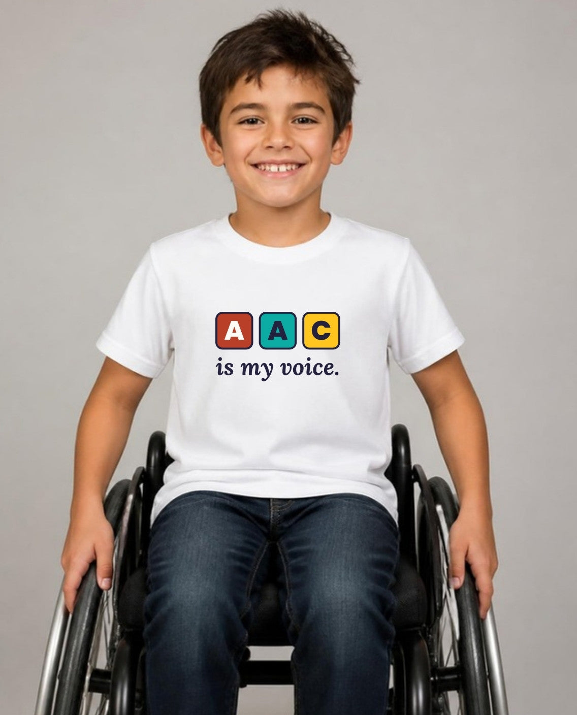 Boy who uses a wheelchair wearing the AAC Is My Voice Youth Tee in White