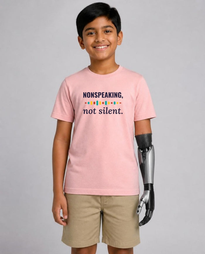 Boy with a prosthetic arm wearing the Nonspeaking, Not Silent Youth Tee in Pink