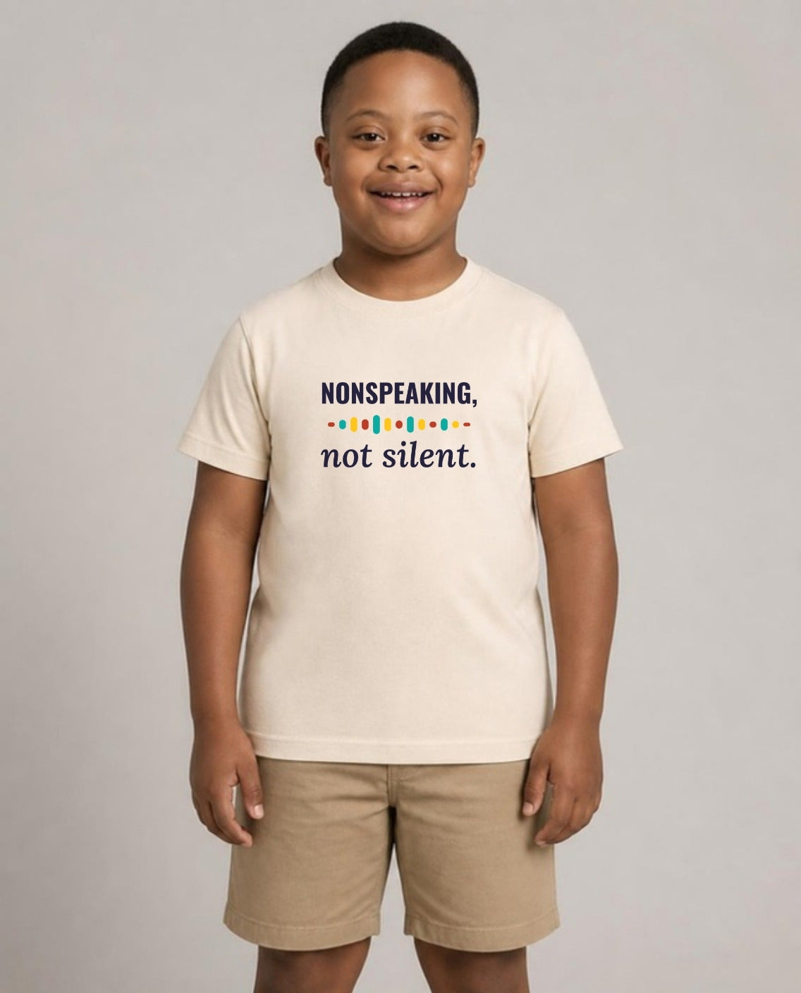 Boy with Down syndrome wearing the Nonspeaking, Not Silent Youth Tee in Natural