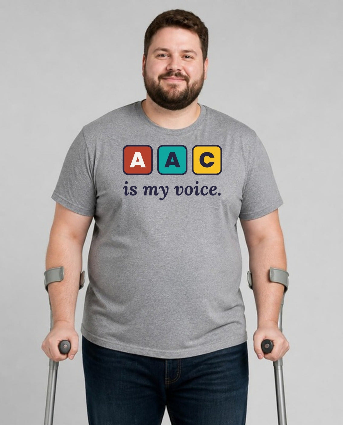 Man who uses forearm crutches wearing the AAC Is My Voice Adult Tee in Athletic Heather