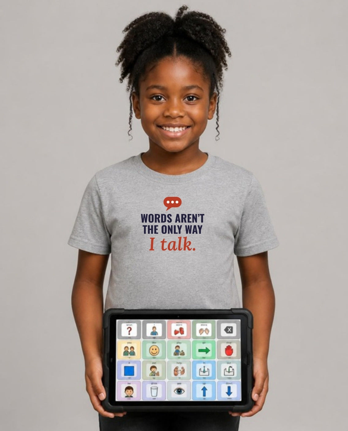 Girl holding her AAC talker wearing the Words Aren’t the Only Way I Talk Youth Tee in Athletic Heather