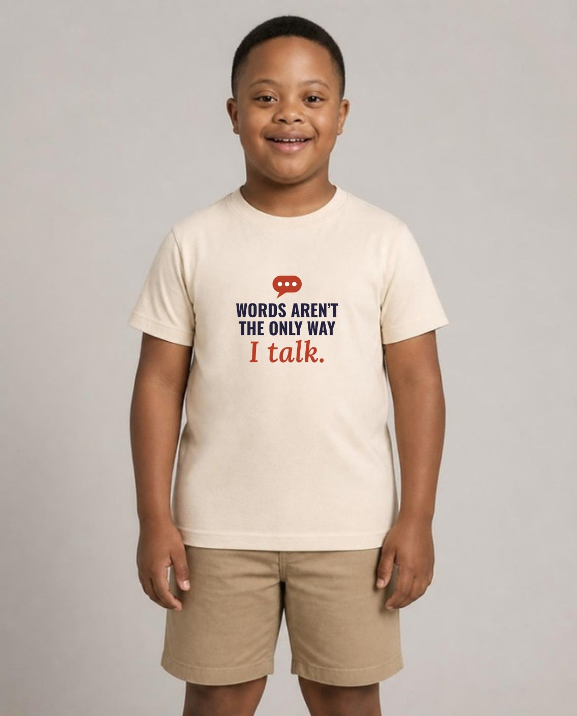 Boy with Down syndrome wearing the Words Aren’t the Only Way I Talk Youth Tee in Natural