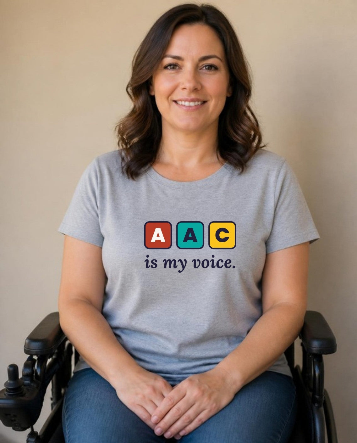 Woman who uses a power wheelchair wearing the AAC Is My Voice Adult Tee in Athletic Heather