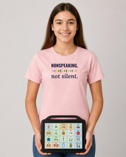 Teen holding her AAC talker wearing the Nonspeaking, Not Silent Adult Tee in Pink
