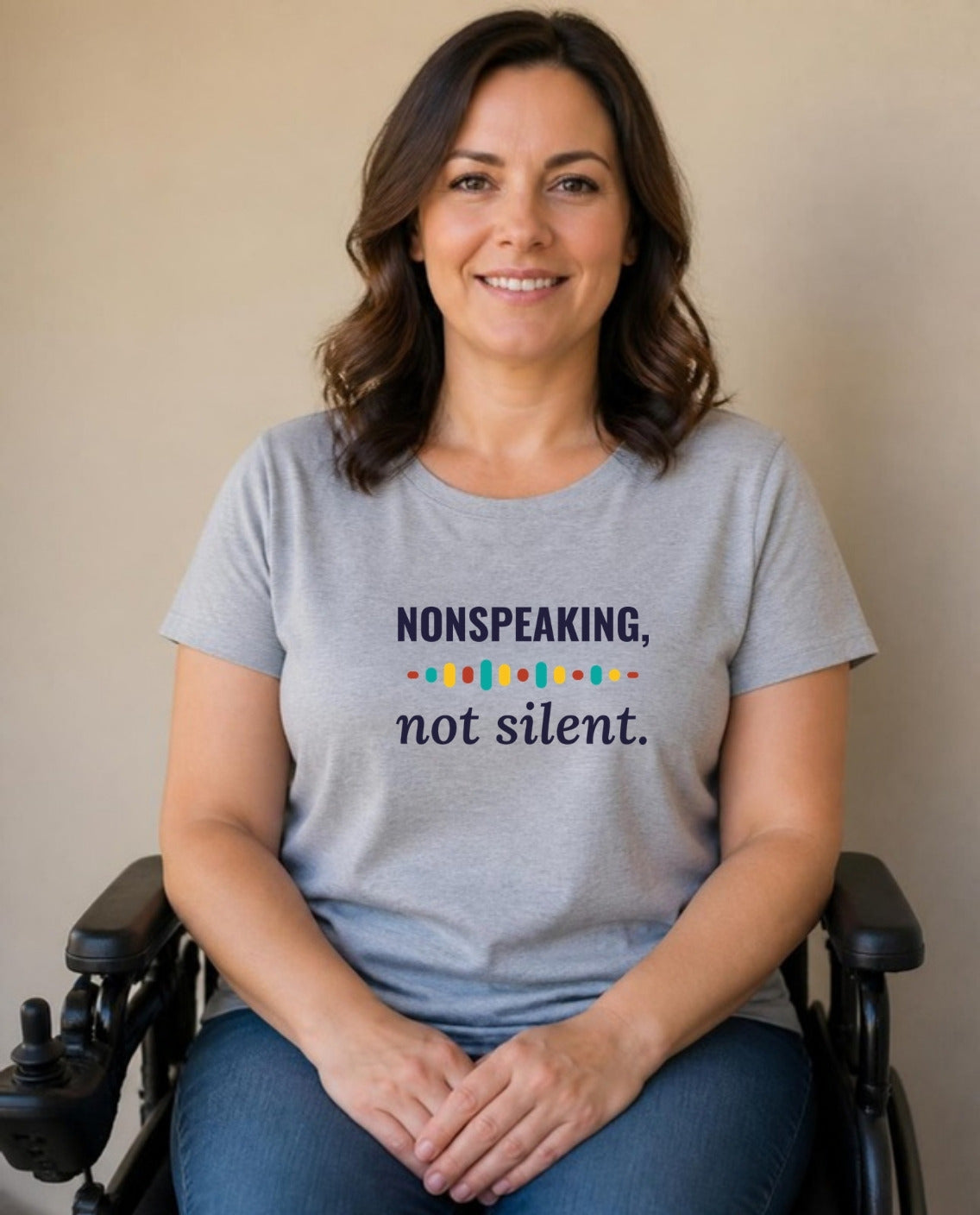 Woman who uses a power wheelchair wearing the Nonspeaking, Not Silent Adult Tee in Athletic Heather