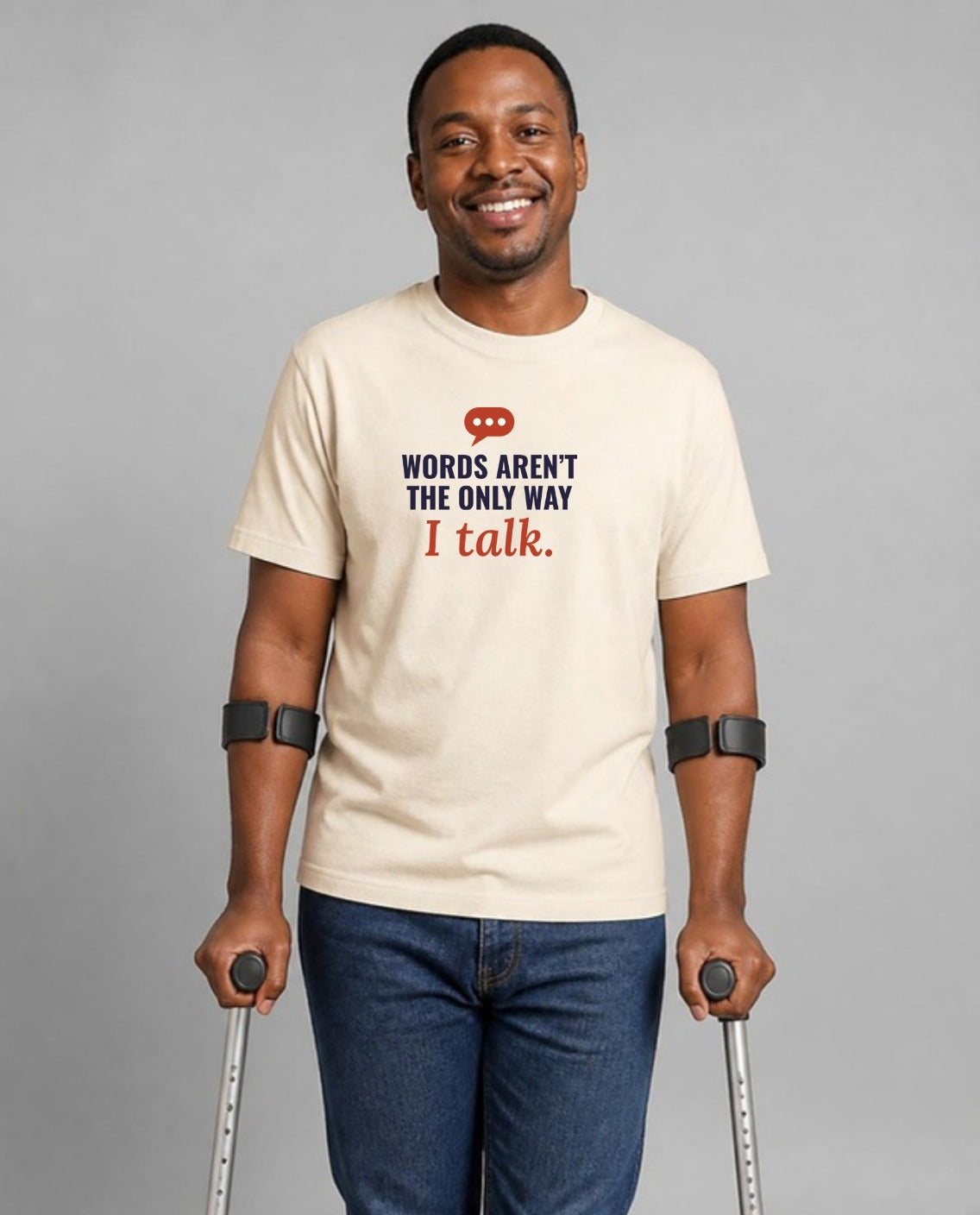 Man who uses forearm crutches wearing the Words Aren’t the Only Way I Talk Adult Tee in Natural