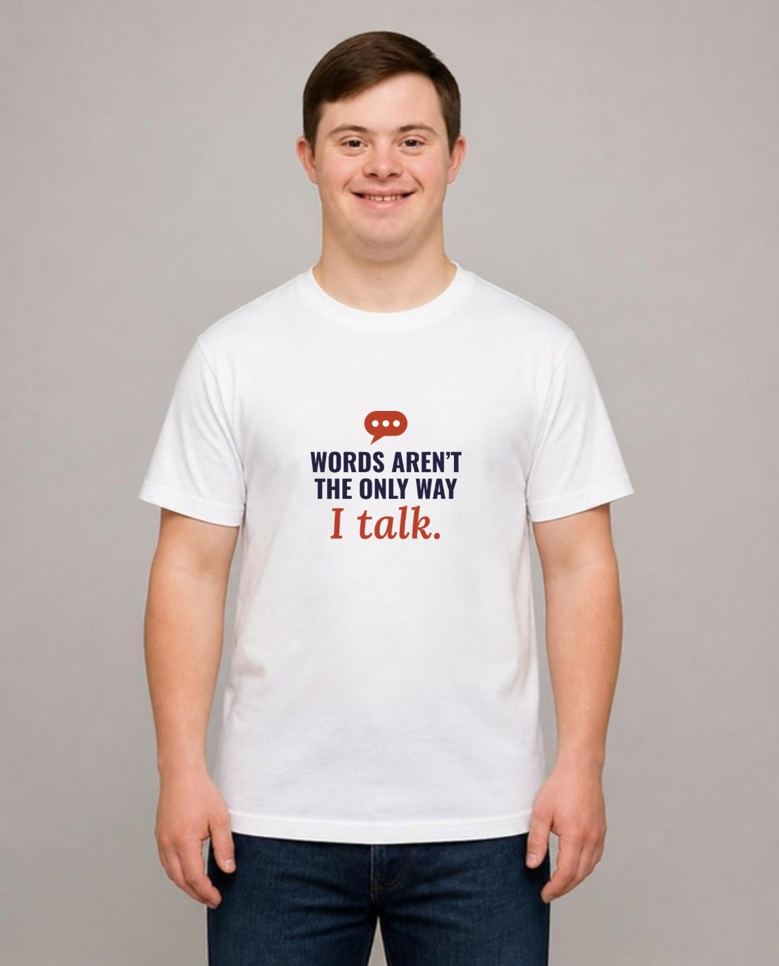 Young man with Down syndrome wearing the Words Aren’t the Only Way I Talk Adult Tee in White