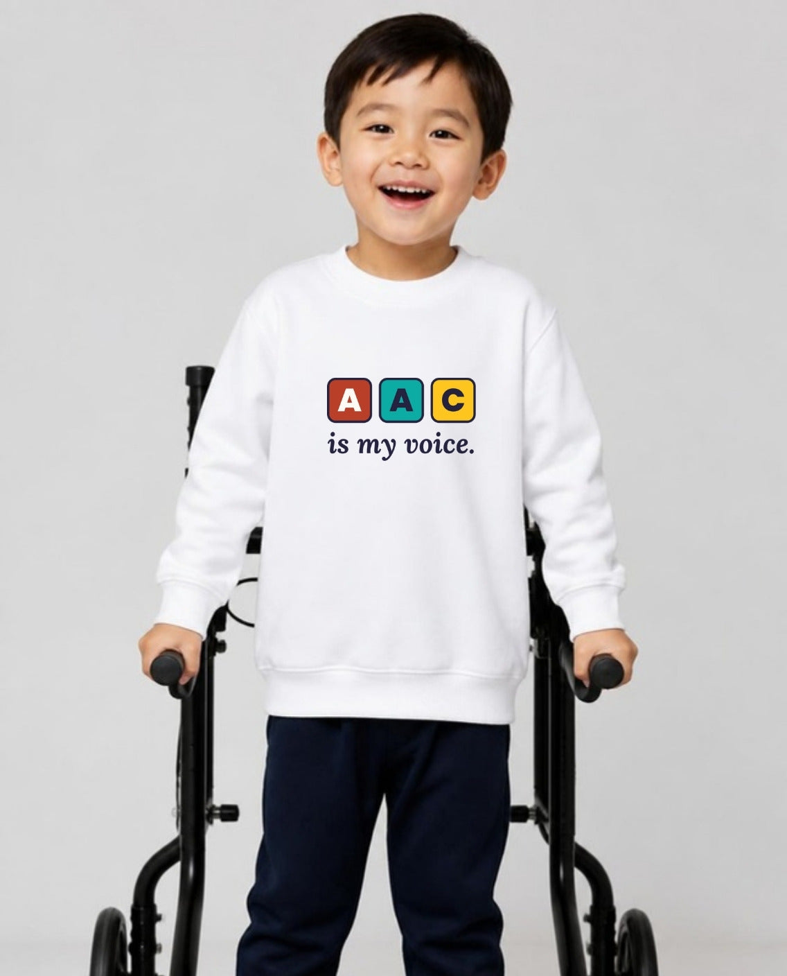 Boy who uses a walker wearing the AAC Is My Voice Youth Sweatshirt in White