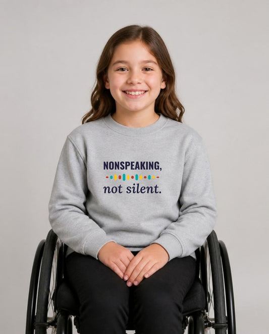Girl who uses a wheelchair wearing the Nonspeaking, Not Silent Youth Sweatshirt in Sport Grey