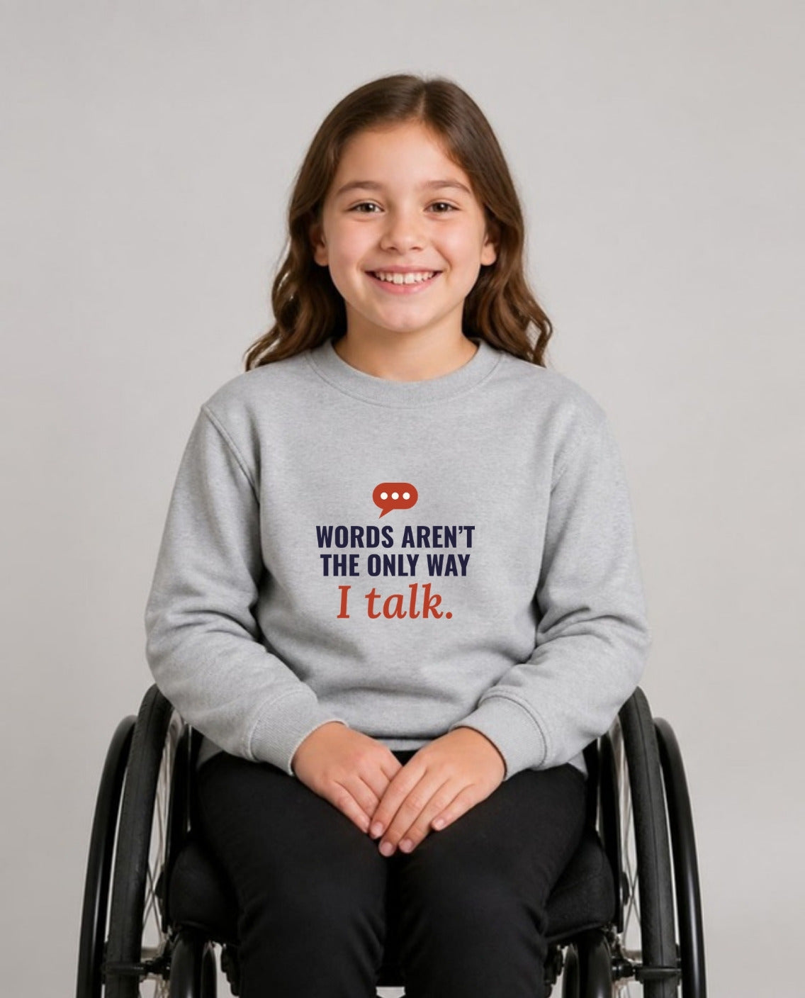 Girl who uses a wheelchair wearing the Words Aren’t the Only Way I Talk Youth Sweatshirt in Sport Grey