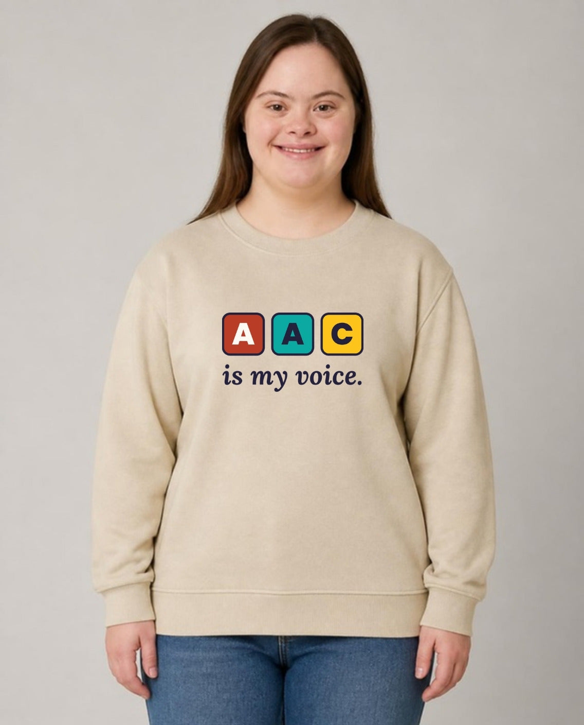 Woman with Down syndrome wearing the AAC Is My Voice Adult Sweatshirt in Sand
