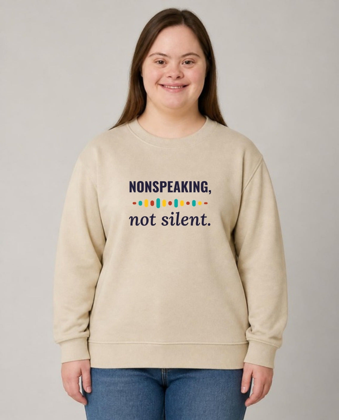 Woman with Down syndrome wearing the Nonspeaking, Not Silent Adult Sweatshirt in Sand