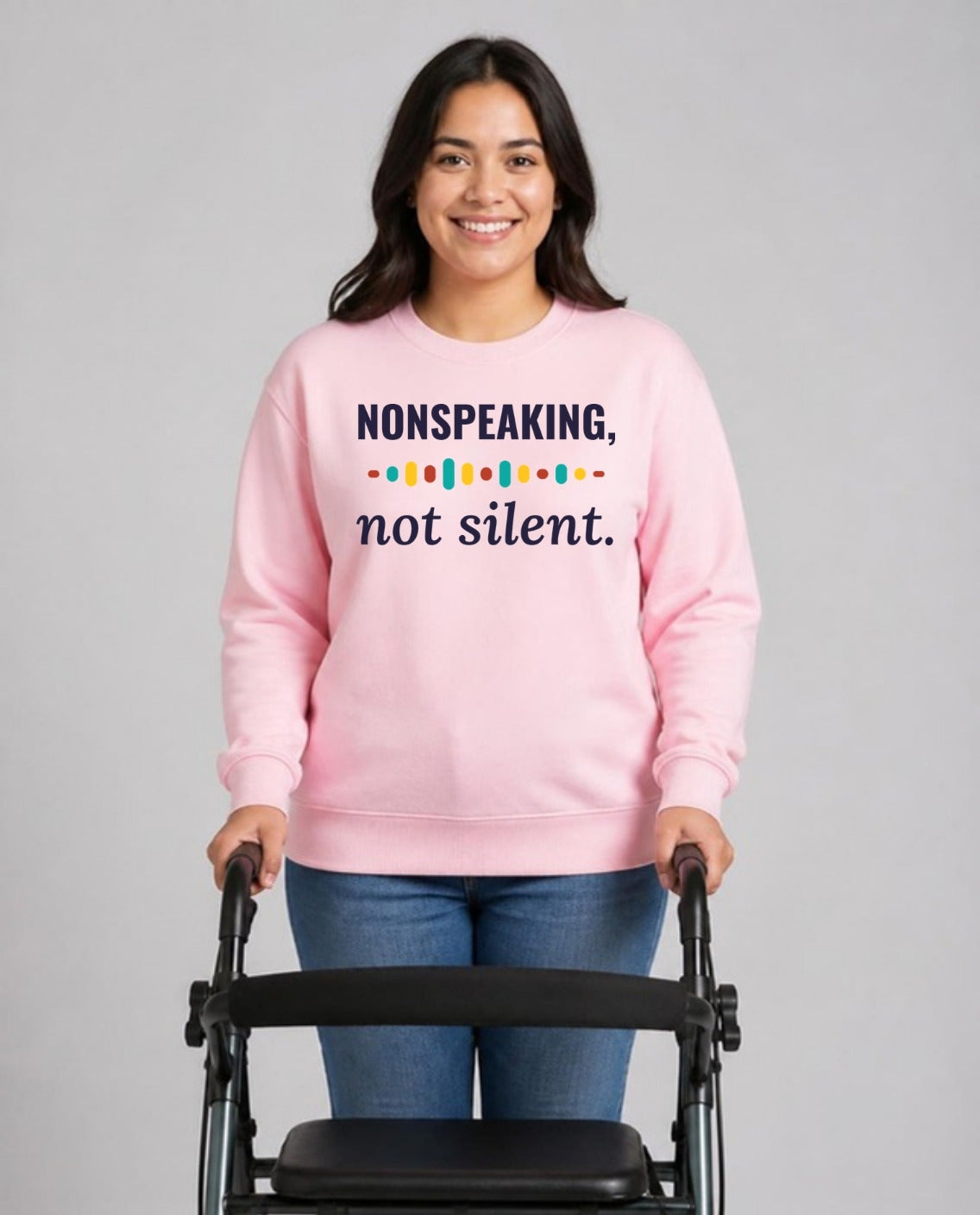 Woman with a rollator walker wearing the Nonspeaking, Not Silent Adult Sweatshirt in Light Pink