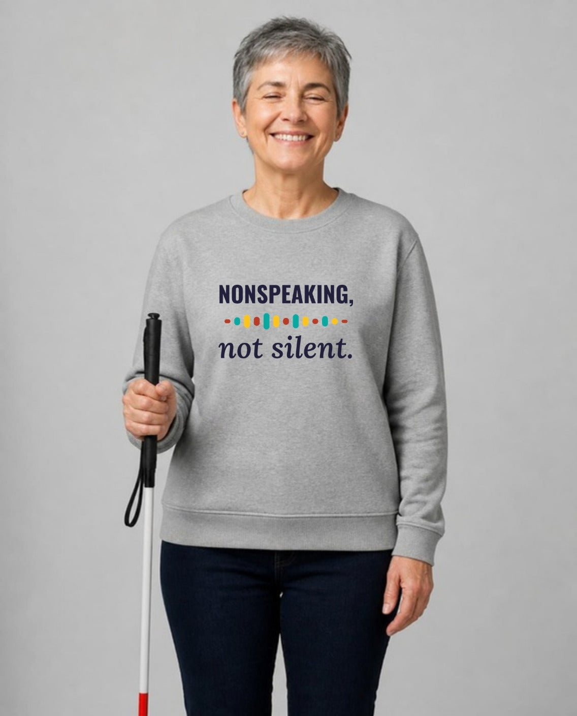 Blind woman with a white cane wearing the Nonspeaking, Not Silent Adult Sweatshirt in Sport Grey
