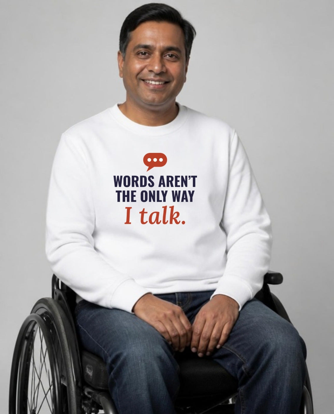 Man who uses a wheelchair wearing the Words Aren’t the Only Way I Talk Adult Sweatshirt in White