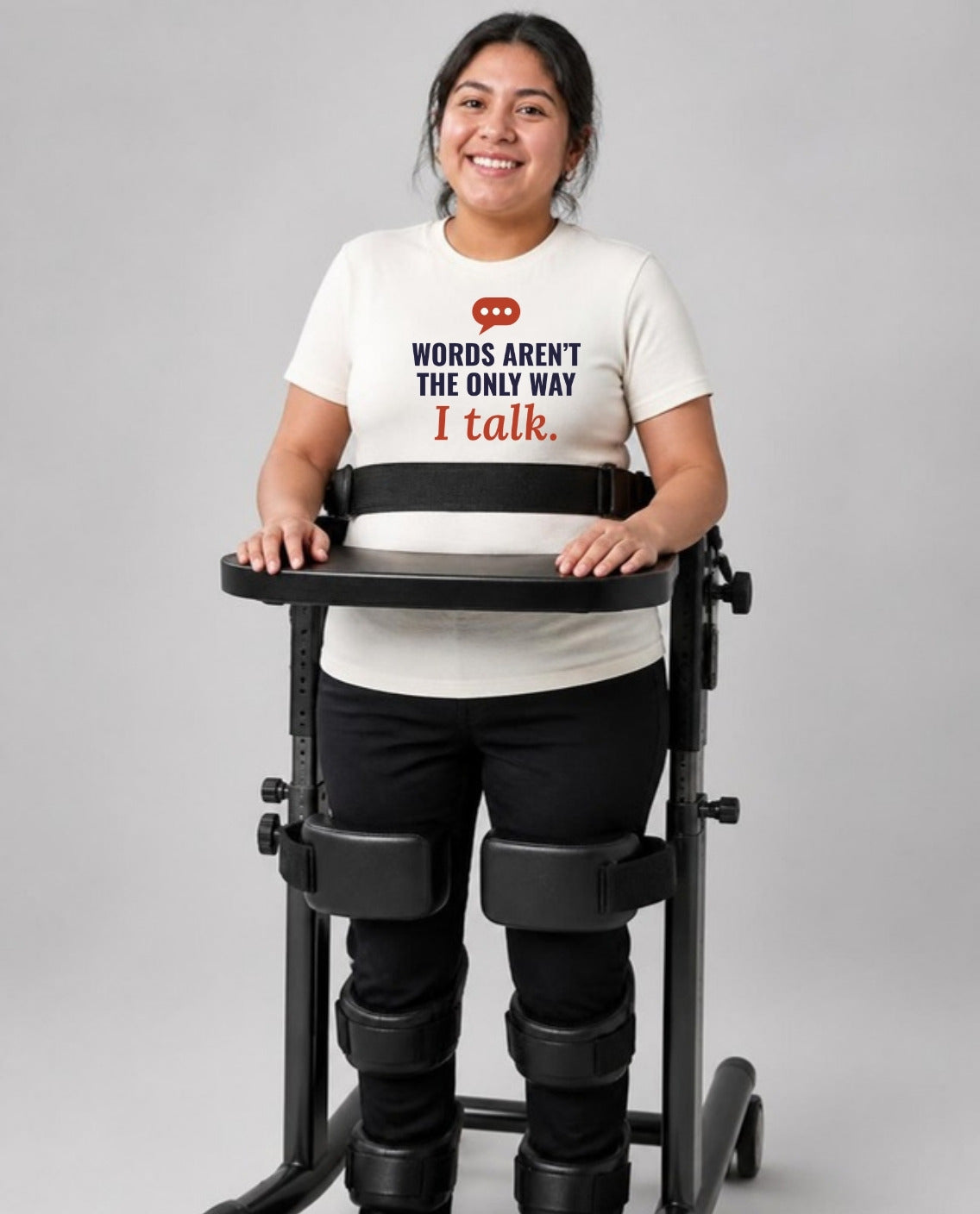 Woman standing in her stander wearing the Words Aren’t the Only Way I Talk Adult Tee in Natural