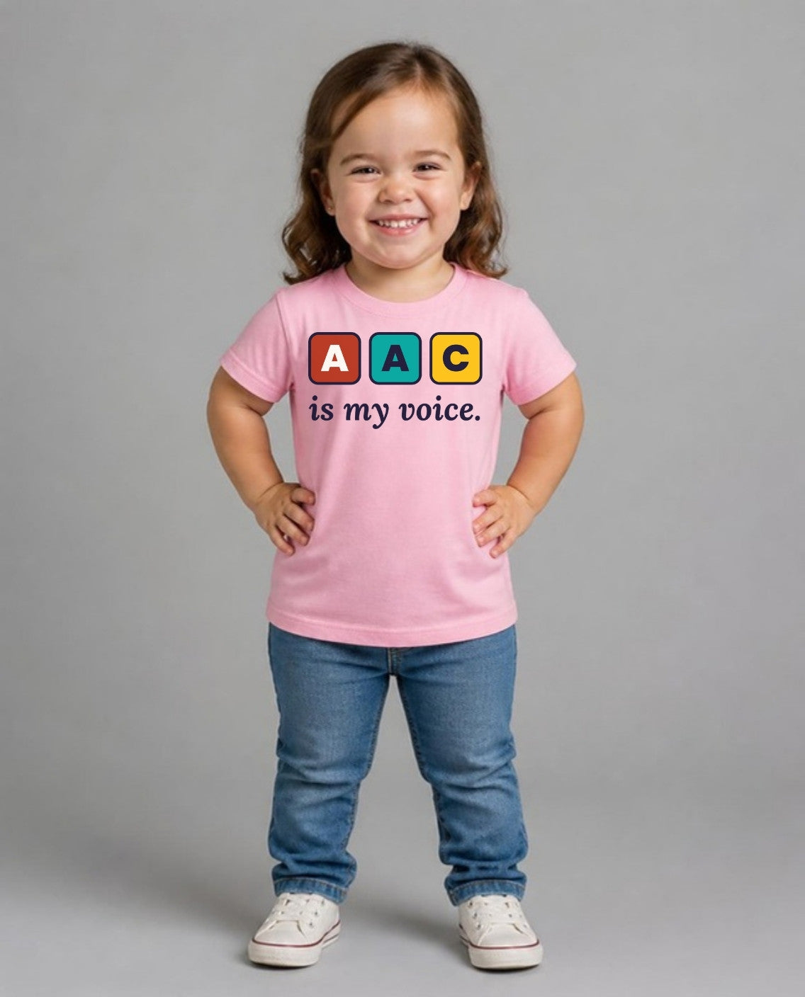 Girl with achondroplasia wearing the AAC Is My Voice Youth Tee in Pink