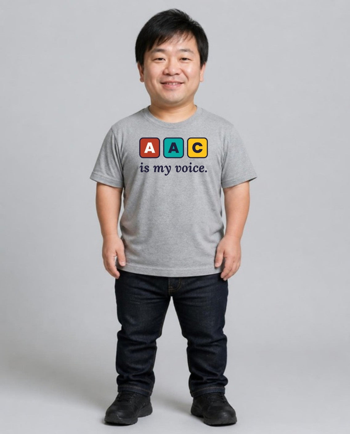 Man with achondroplasia wearing the AAC Is My Voice Adult Tee in Athletic Heather