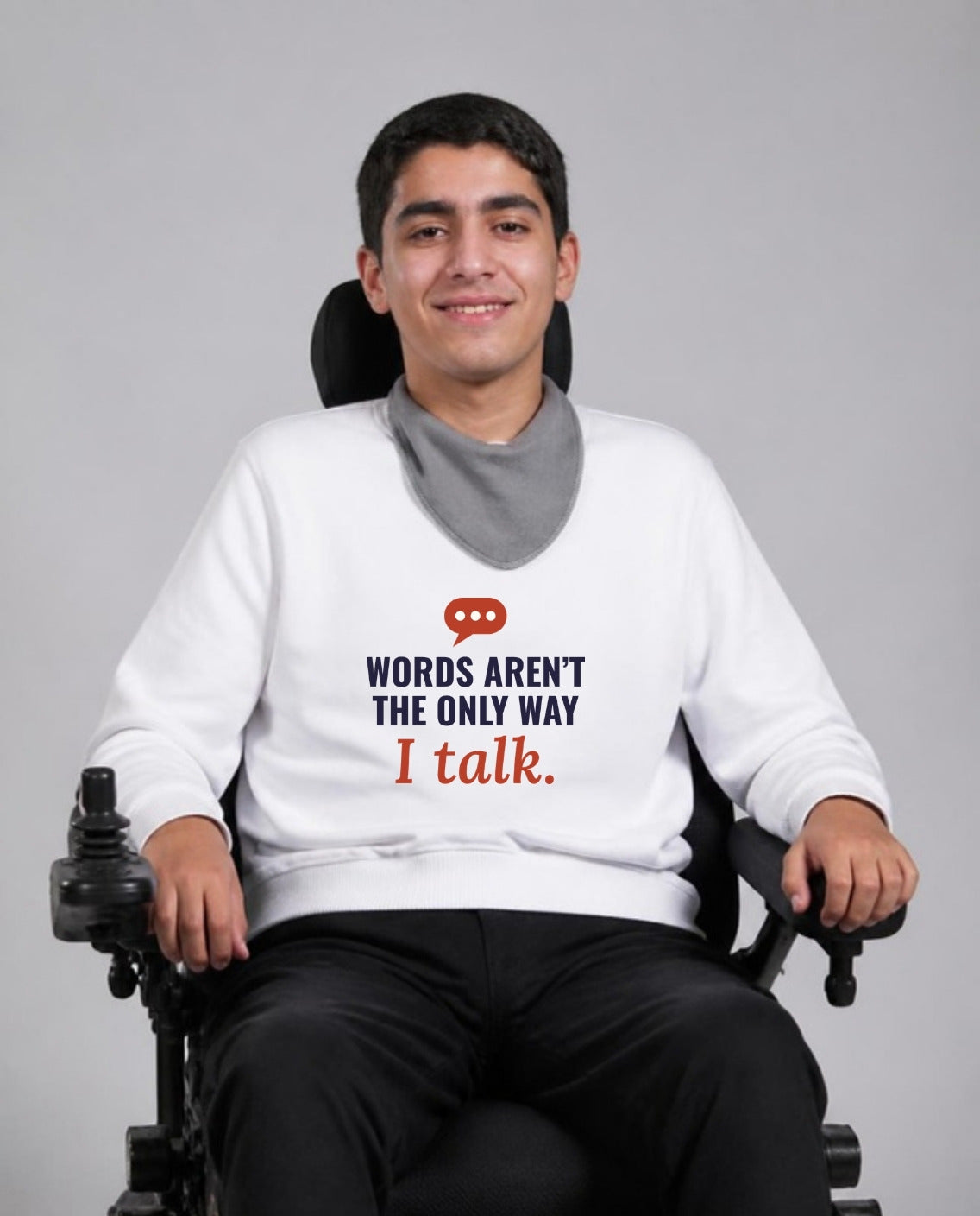 Man who uses a power wheelchair wearing the Words Aren’t the Only Way I Talk Adult Sweatshirt in White