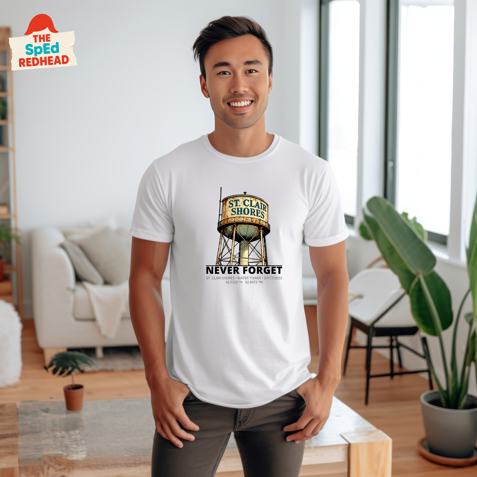 Man wearing a white t-shirt with a graphic design in a living room.