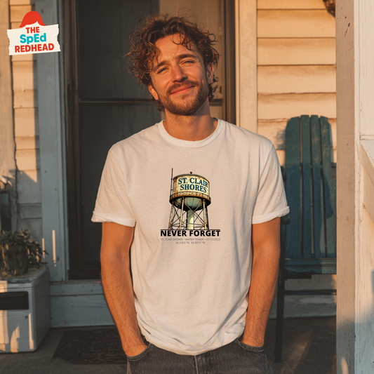 Man wearing a t-shirt with a graphic design standing in front of a building.