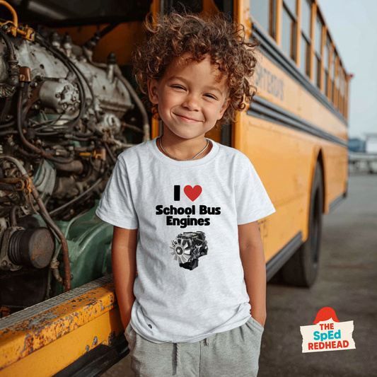 Child wearing a t-shirt with 'I ❤️ School Bus Engines' design in front of a school bus.