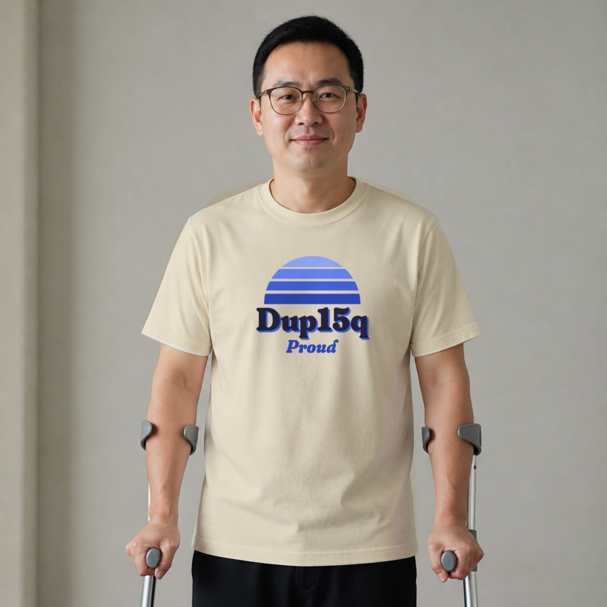 A man standing with two forearm crutches wears a natural-colored Dup15q Proud tee.
