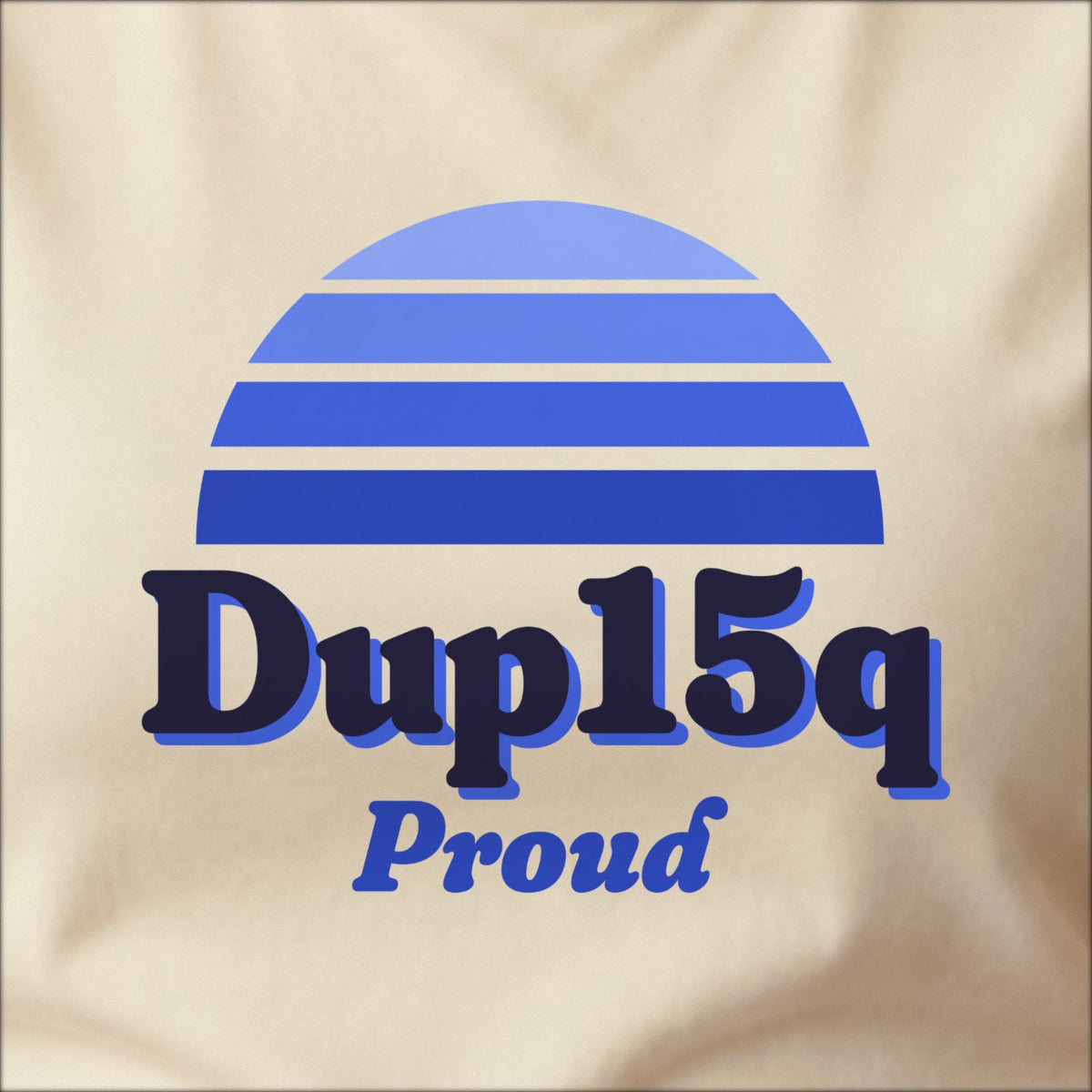 Close-up of the print on a natural tee: a striped half-sun in blue above bold DUP15q lettering with “Proud” in script.