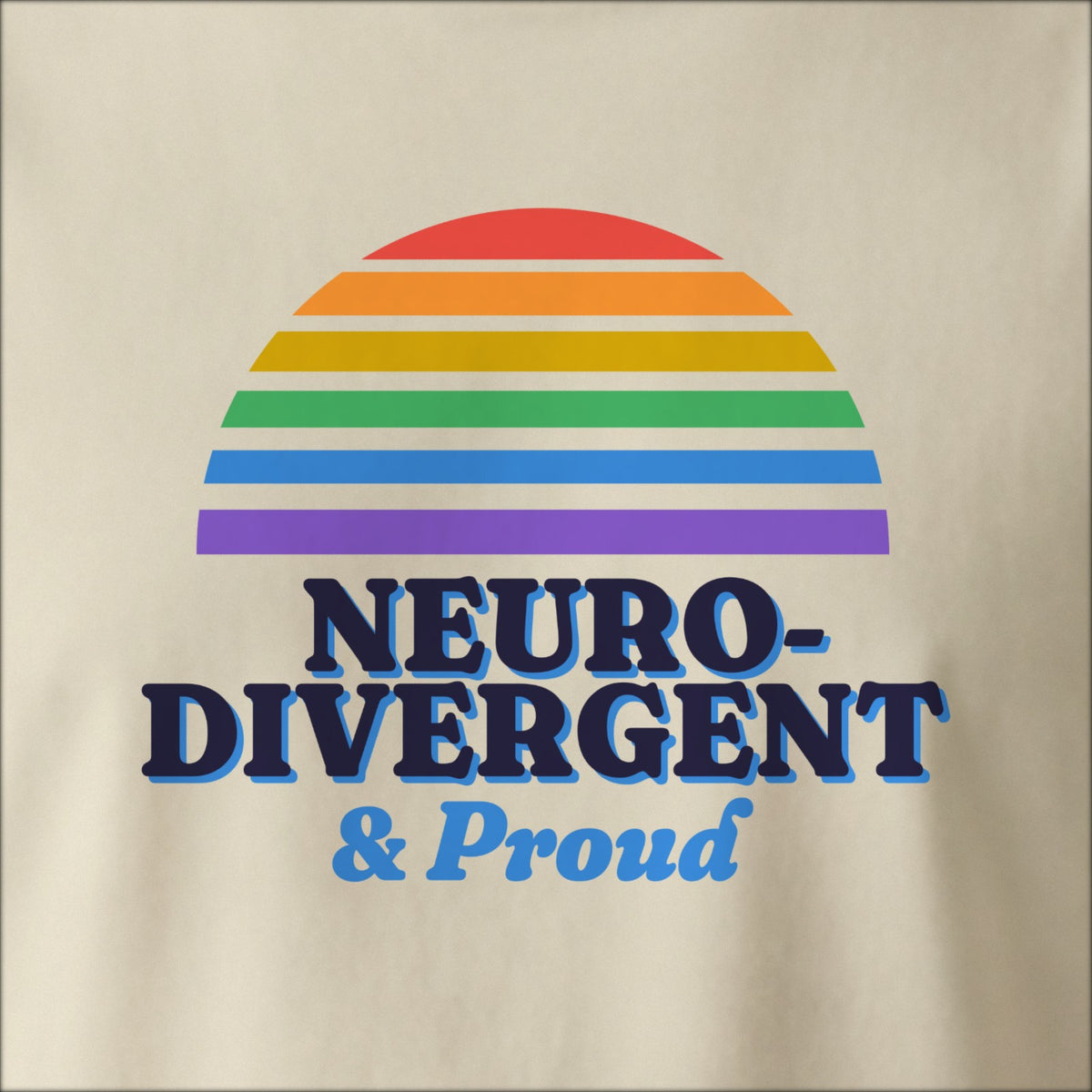 Close-up of the print on a natural tee: a six-stripe rainbow half-sun above bold NEURODIVERGENT lettering with “& Proud” in script.