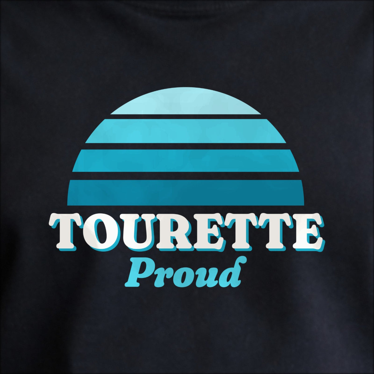 Close-up of the print on black: a striped half-sun in teal above cream TOURETTE lettering with “Proud” in script.